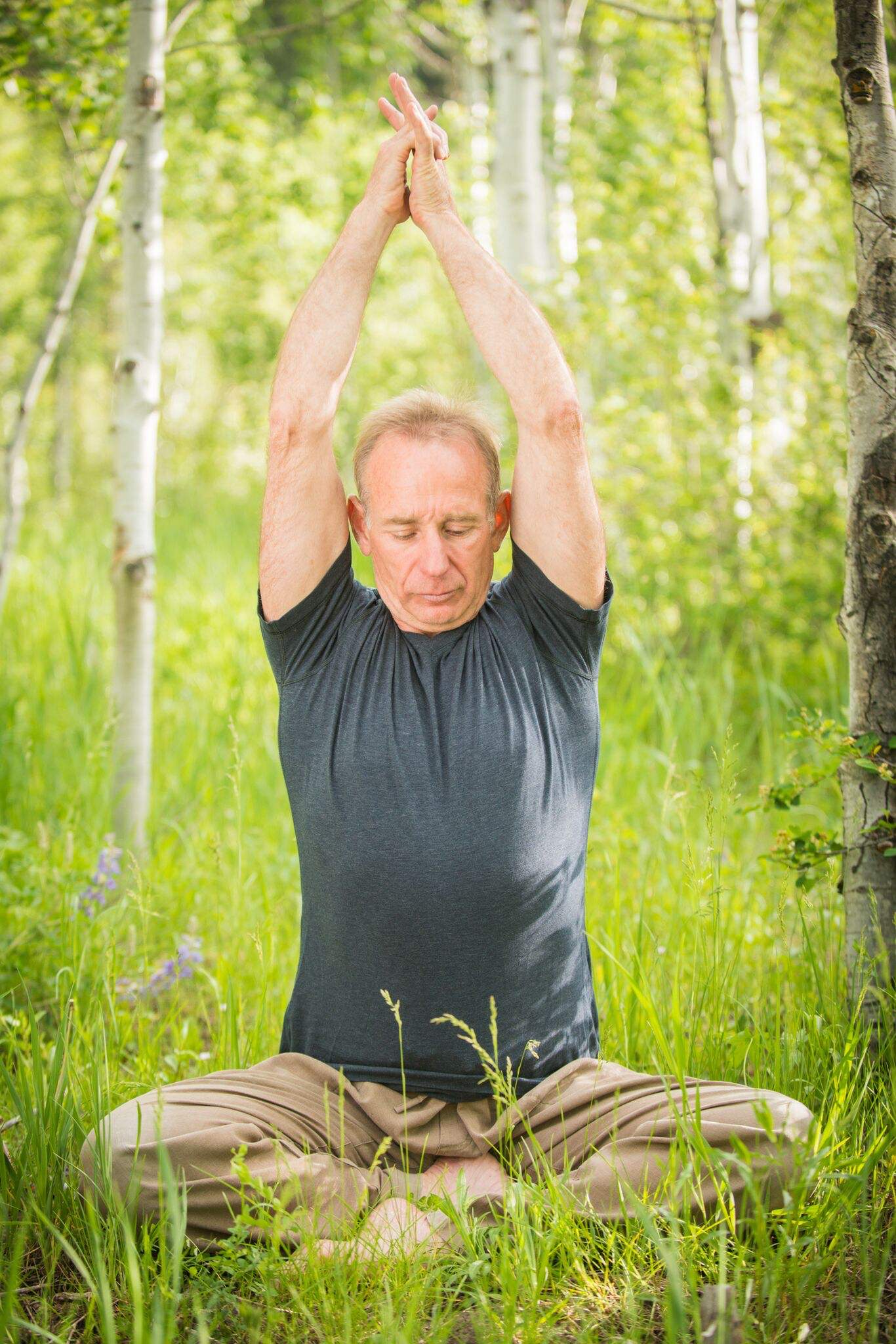 Ed Harrold in yoga practice among aspen trees